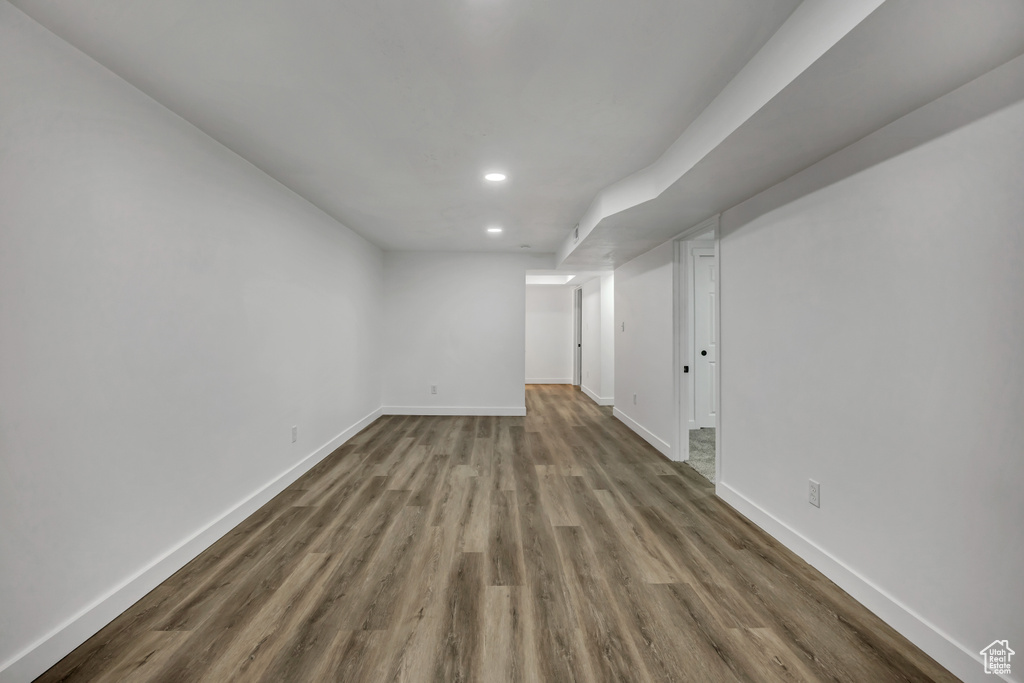 Finished basement with wood finished floors and recessed lighting