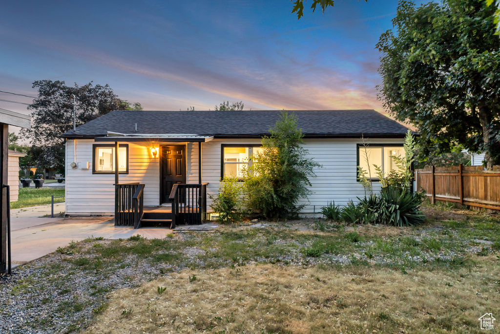 Ranch-style home with roof with shingles