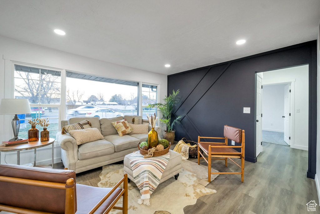 Living area with wood finished floors and recessed lighting