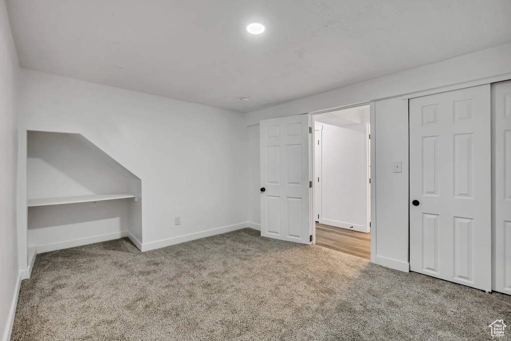 Unfurnished bedroom featuring carpet and a closet
