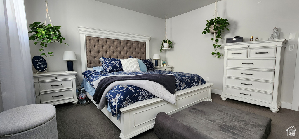 Bedroom with dark colored carpet