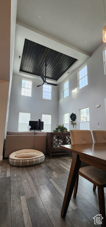 Dining space with hardwood / wood-style flooring and a high ceiling