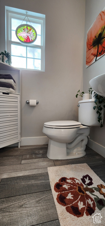 Bathroom featuring toilet and wood finished floors