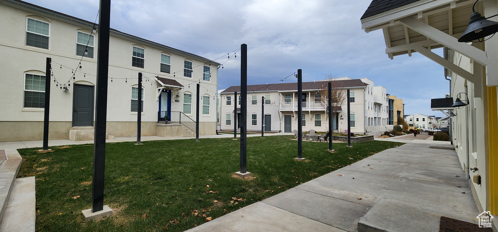 Surrounding community with a residential view and a lawn