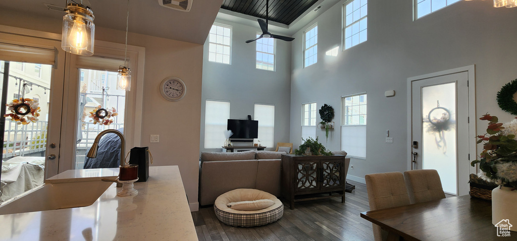Dining area featuring a towering ceiling, wood finished floors, and a chandelier