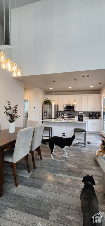 Dining room with a high ceiling and recessed lighting