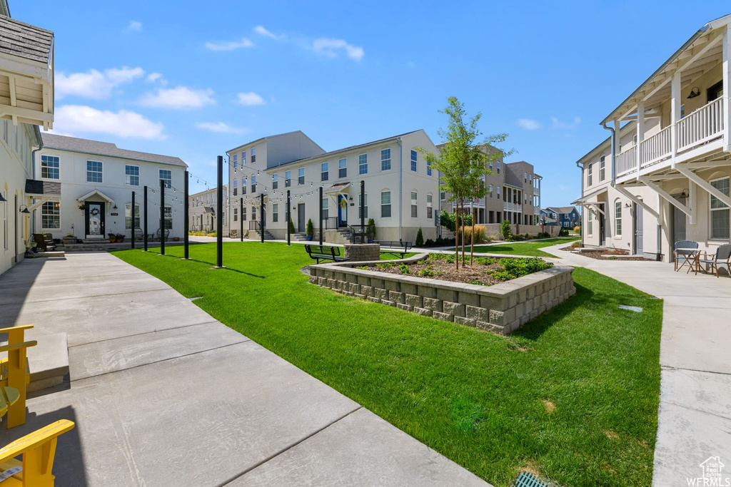 View of property\'s community featuring a residential view and a lawn