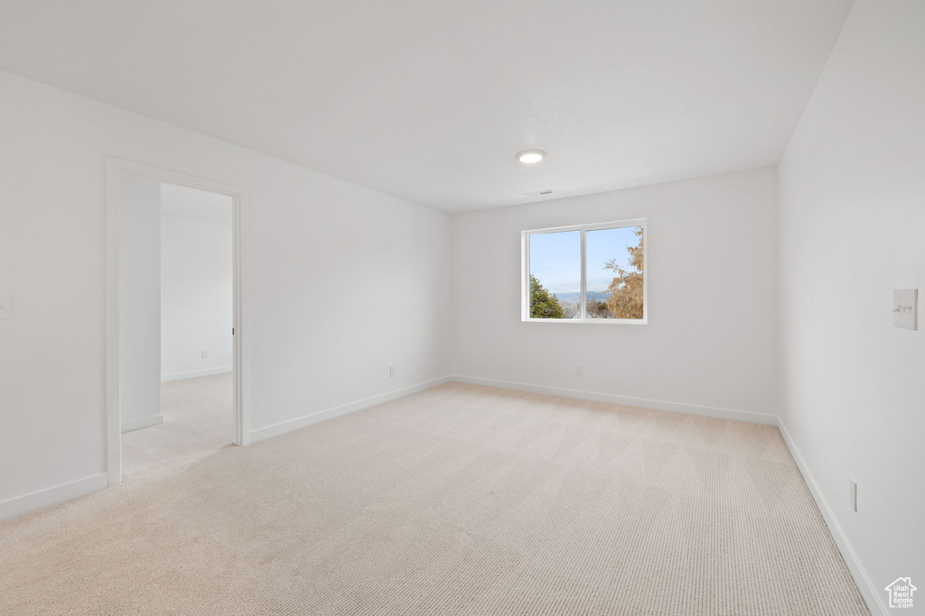 Empty room with light colored carpet