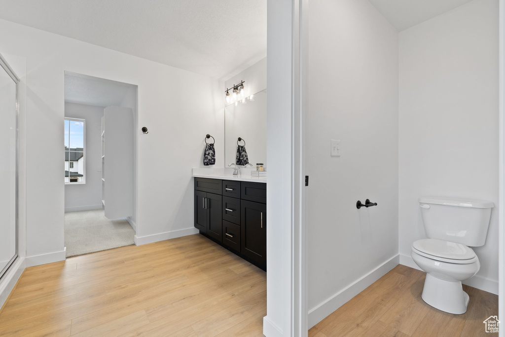 Bathroom featuring vanity and wood finished floors