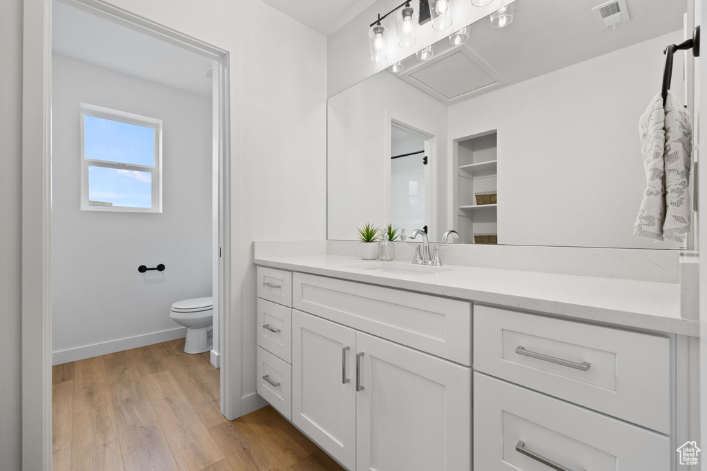 Bathroom featuring vanity and wood finished floors