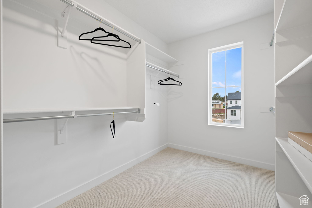 Walk in closet with carpet flooring
