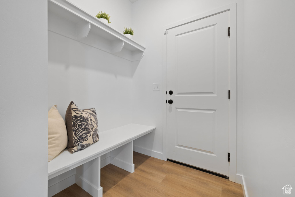Mudroom featuring light wood-style floors and baseboards