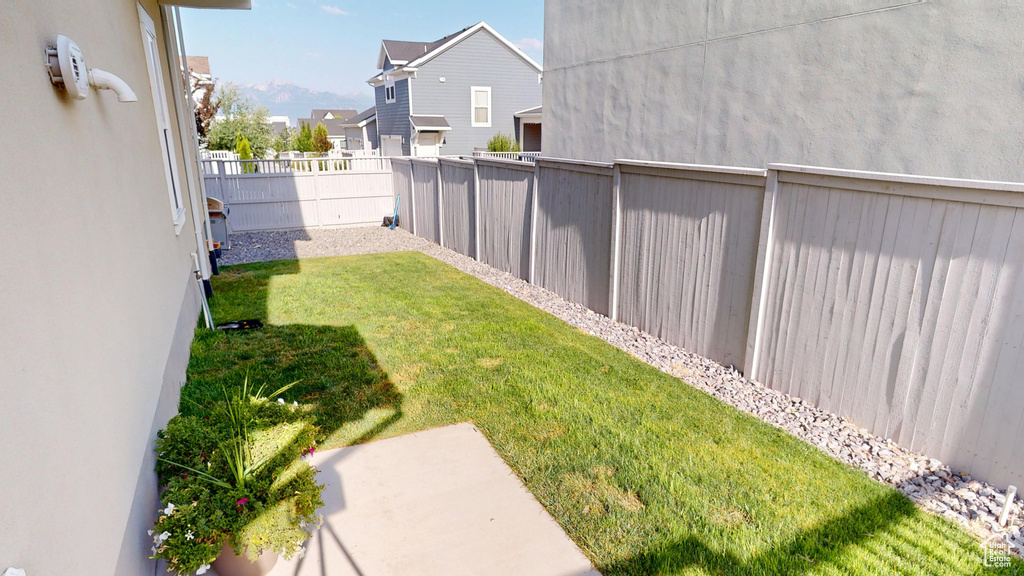 Fenced backyard featuring a residential view