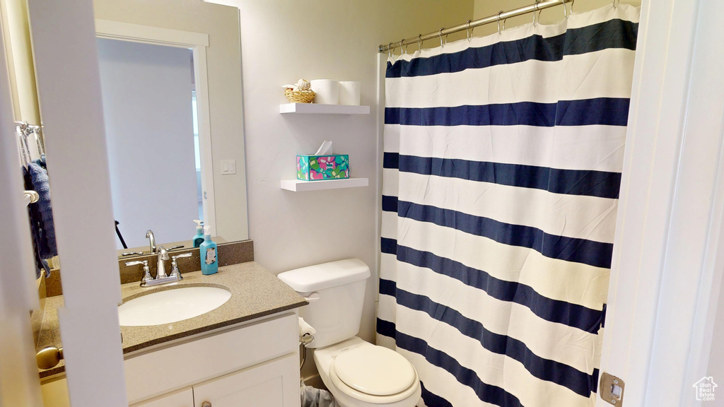 Full bath with vanity and a shower with curtain