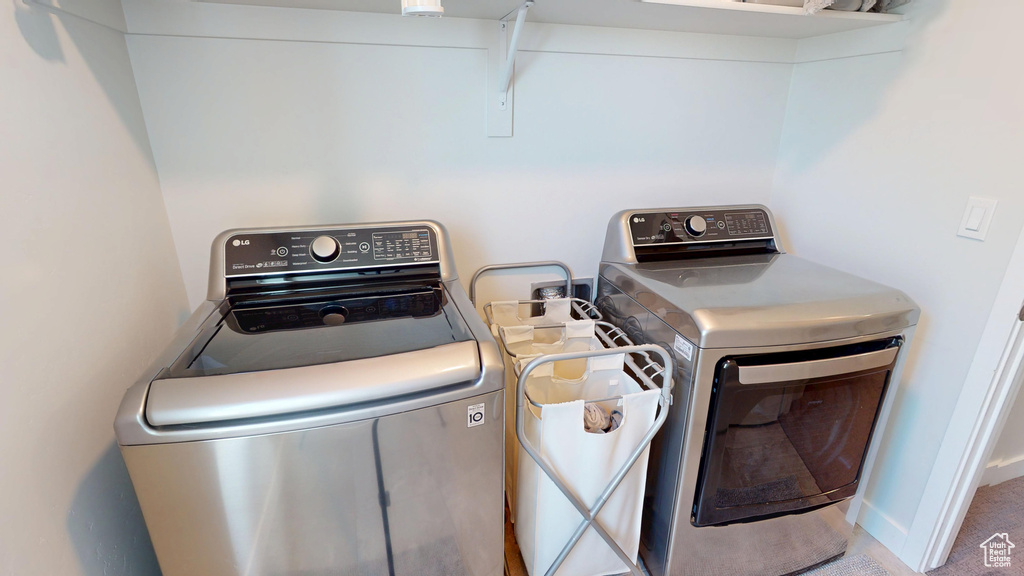 Washroom with washing machine and clothes dryer