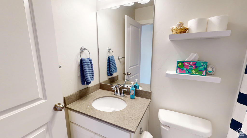 Bathroom featuring vanity and toilet