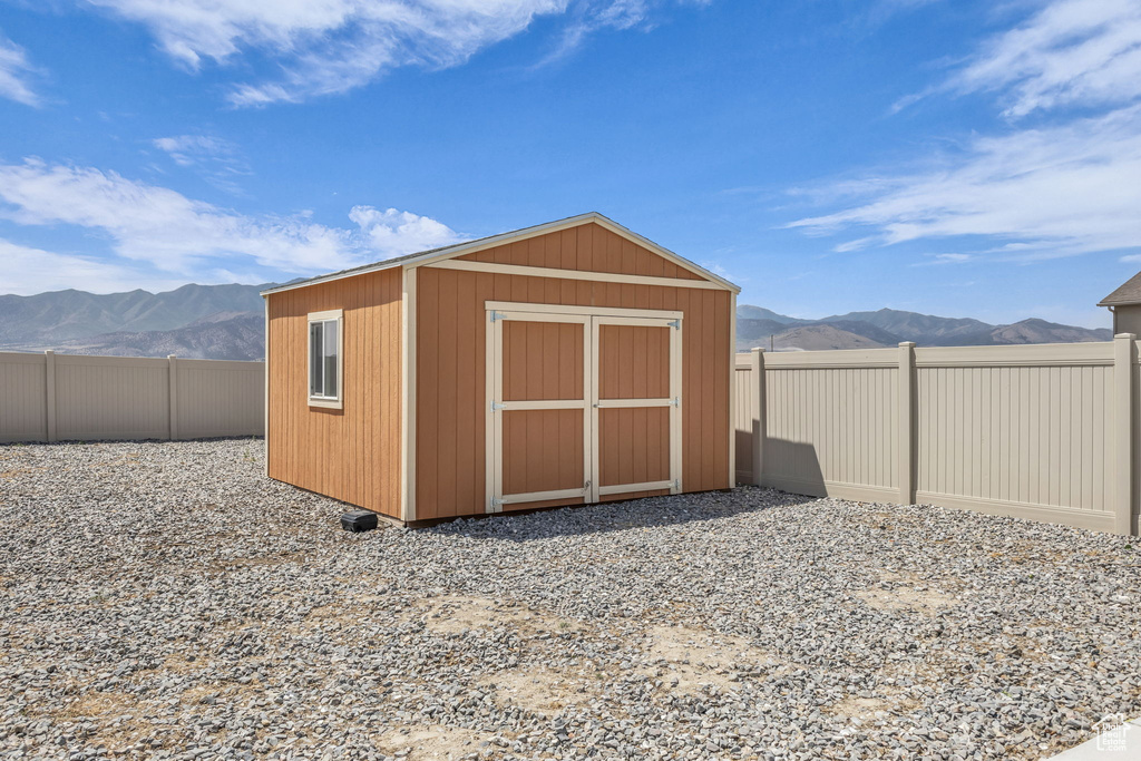 View of shed with a mountain view and a fenced backyard