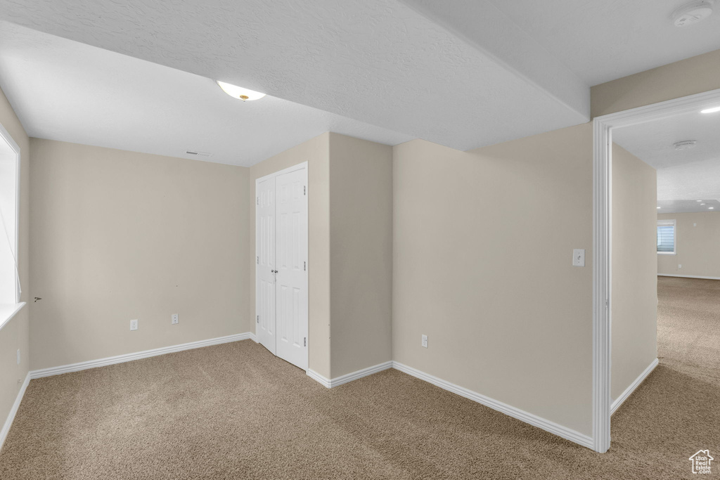Spare room with carpet and a smoke detector