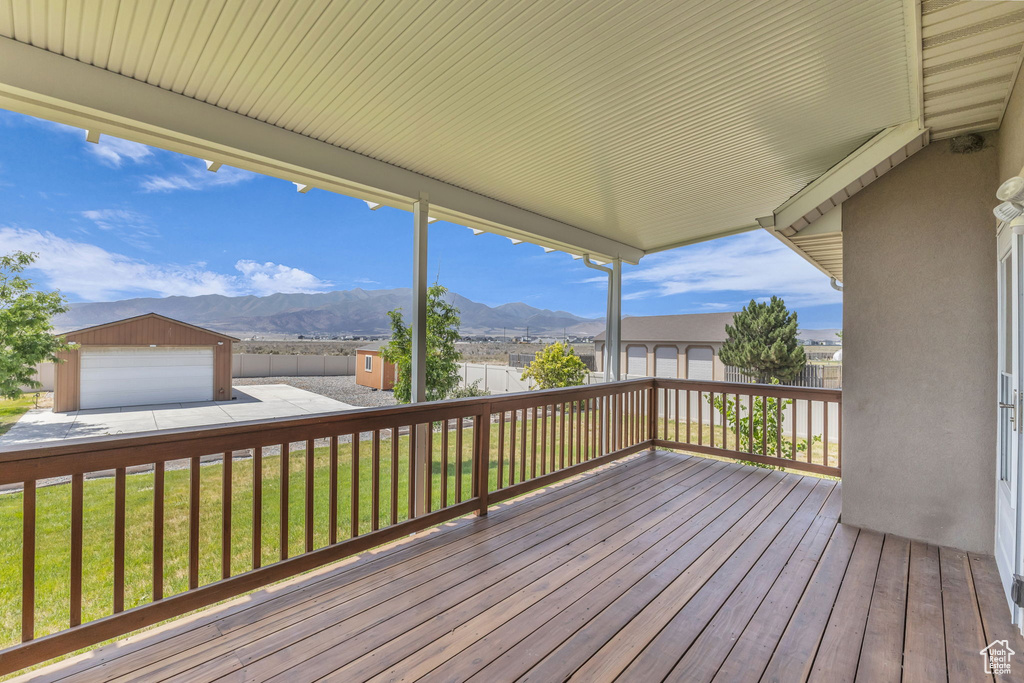 Wooden deck featuring an outdoor structure and a mountain view