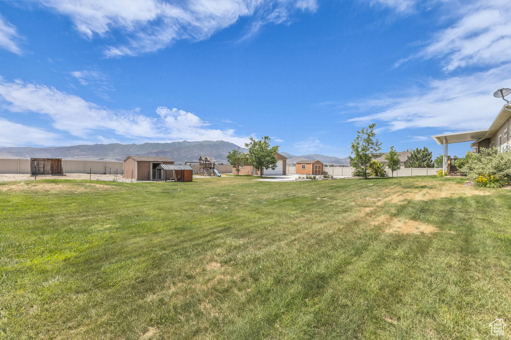 View of yard featuring a storage unit and a mountain view