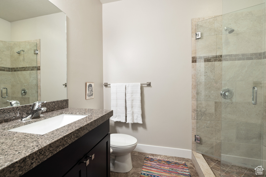 Bathroom featuring a stall shower and vanity