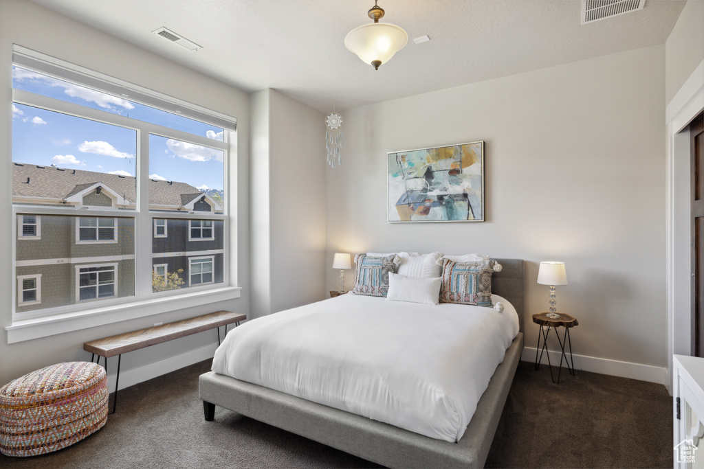 Bedroom featuring carpet floors and baseboards