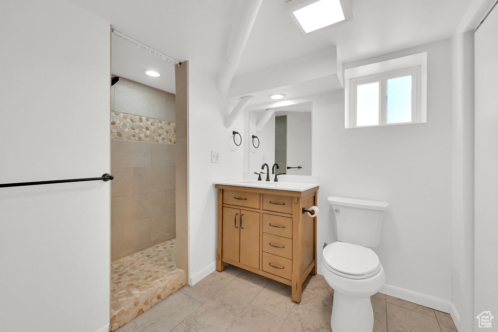 Bathroom featuring walk in shower, vanity, and recessed lighting