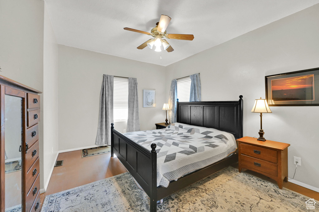 Bedroom with light wood finished floors and ceiling fan