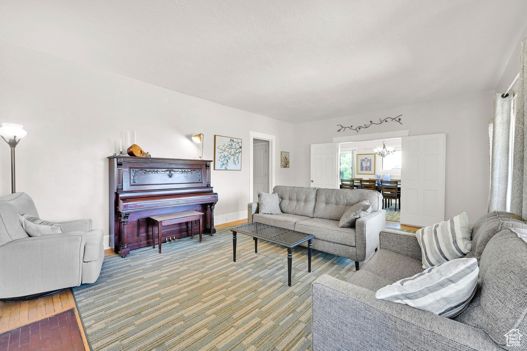 Living room featuring a chandelier and light wood-type flooring