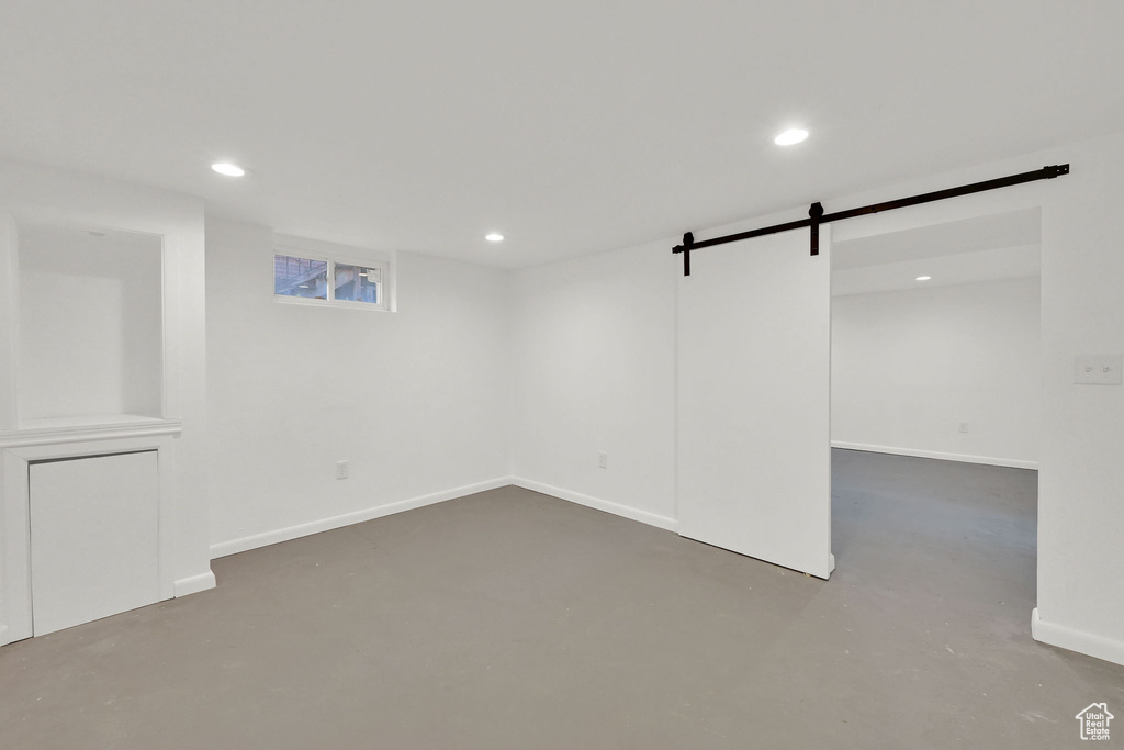 Below grade area with a barn door and recessed lighting