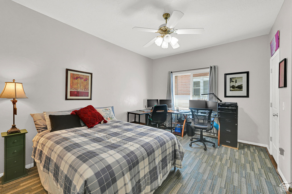 Bedroom featuring an office area, ceiling fan, and carpet floors