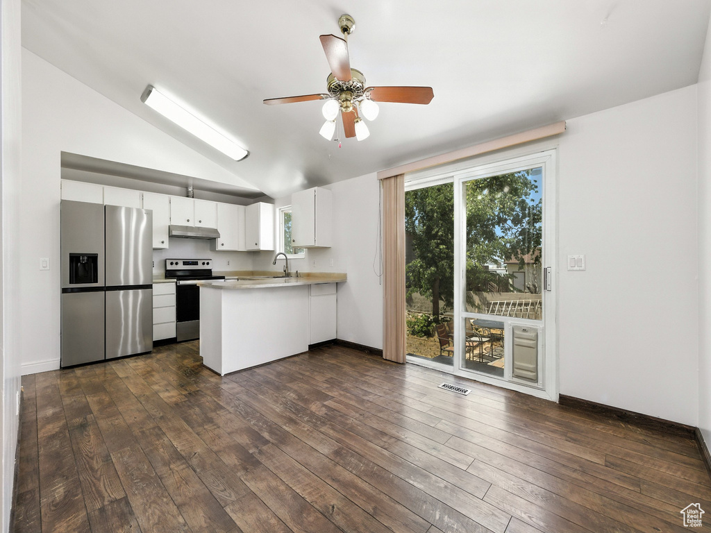 Kitchen with appliances with stainless steel finishes, under cabinet range hood, a peninsula, ceiling fan, and light countertops