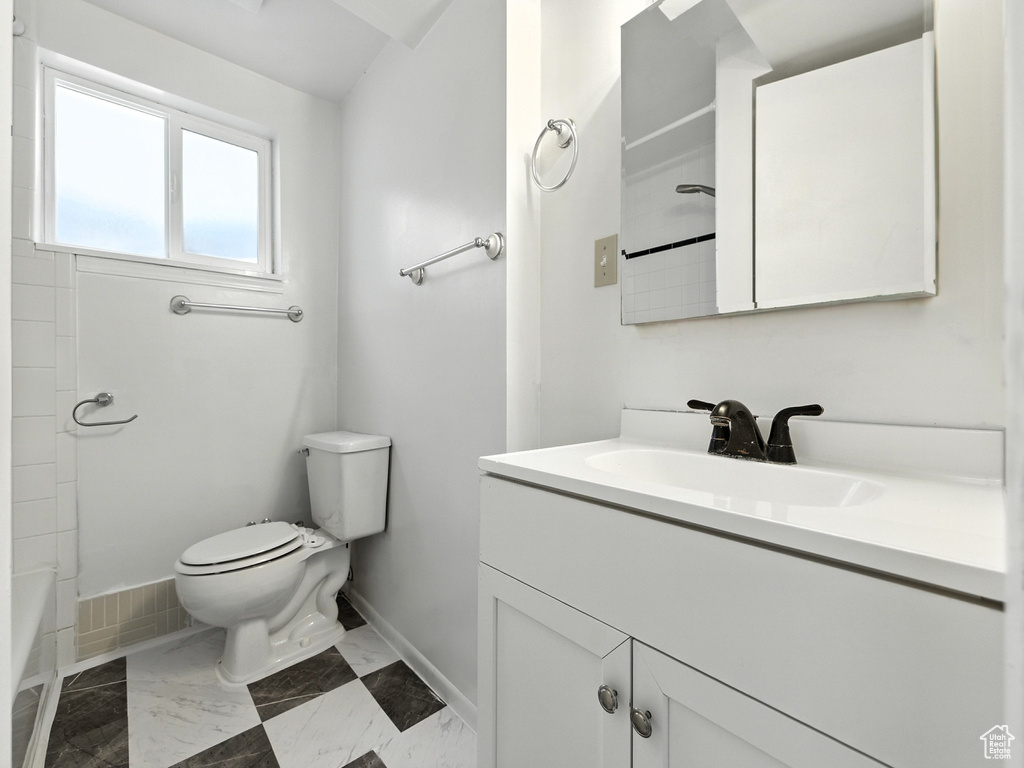Full bath featuring vanity and marble finish floors