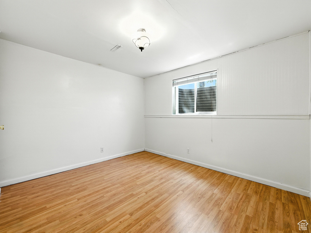 Unfurnished room featuring light wood-style flooring and baseboards