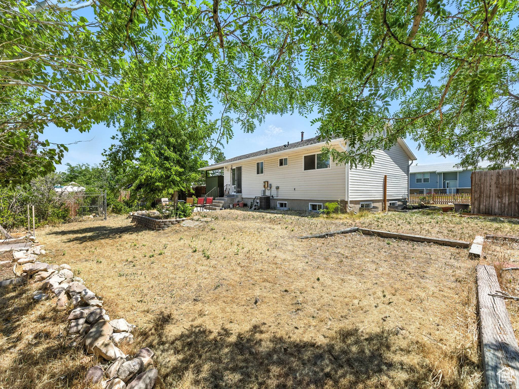 Rear view of property with entry steps and a patio