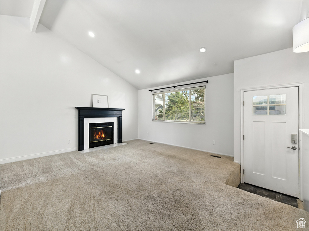 Unfurnished living room with carpet floors, recessed lighting, and a fireplace with flush hearth
