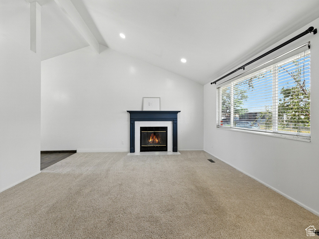 Unfurnished living room with a fireplace with flush hearth, light colored carpet, and recessed lighting