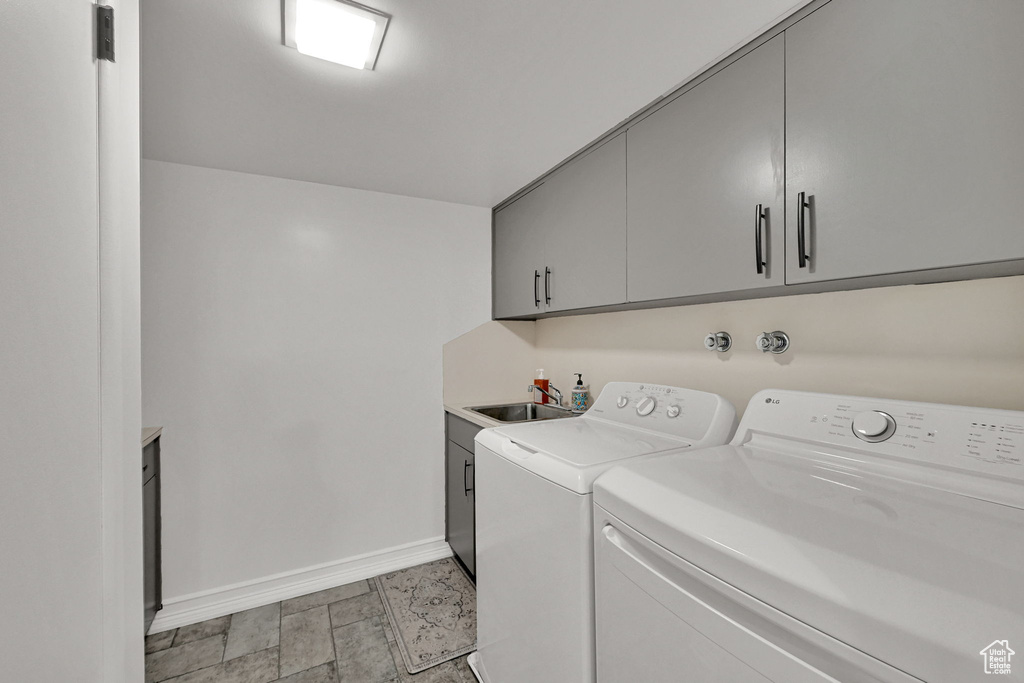 Laundry area with independent washer and dryer and cabinet space