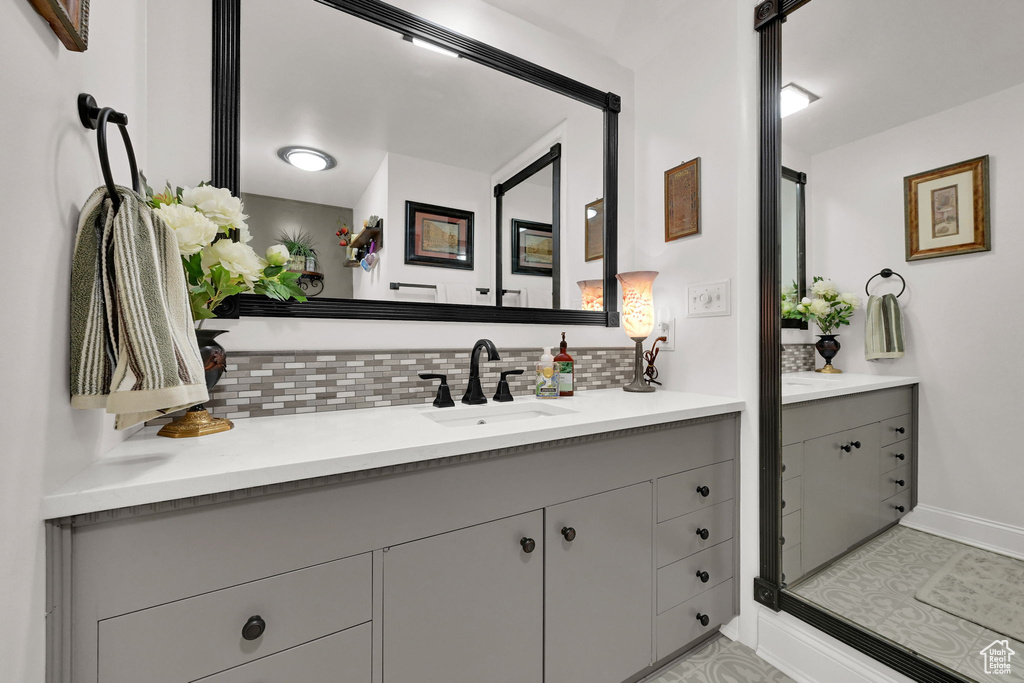 Bathroom featuring backsplash and vanity