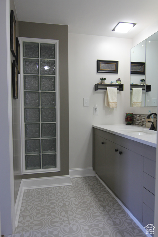 Bathroom featuring baseboards and vanity