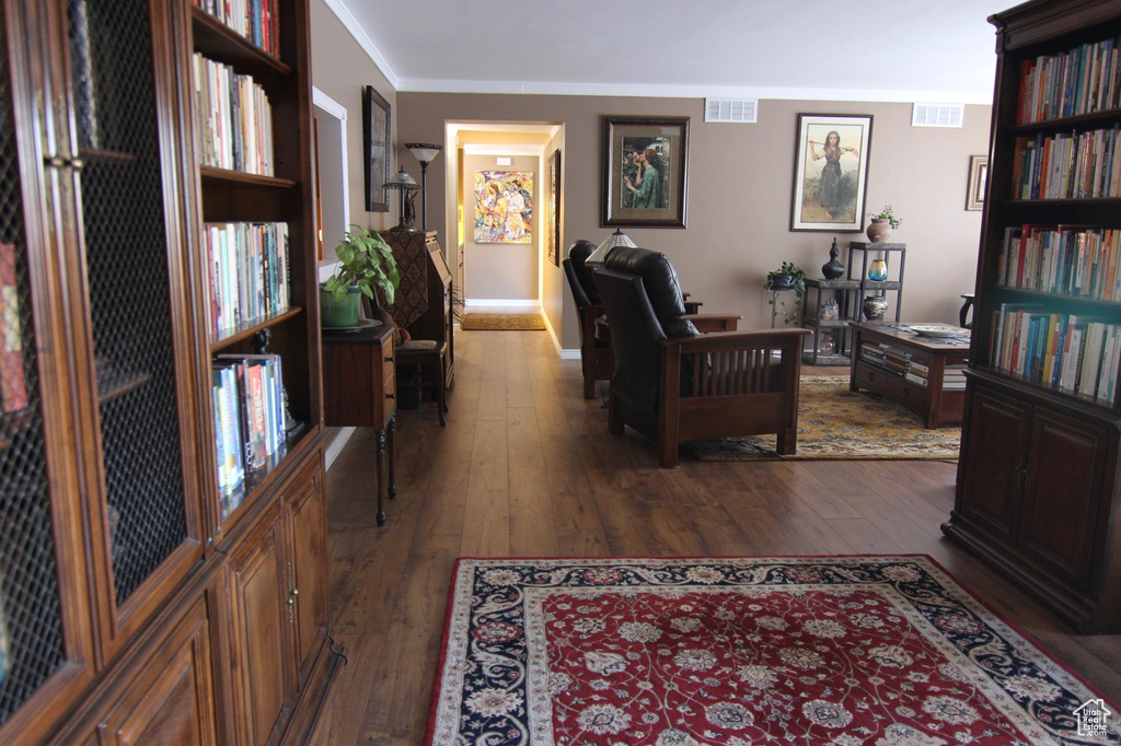 Living room with dark wood-style floors and crown molding