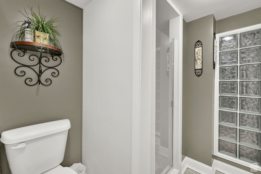 Bathroom with toilet and a stall shower