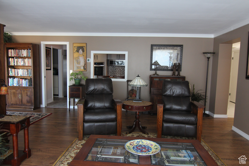 Living area featuring wood finished floors and ornamental molding
