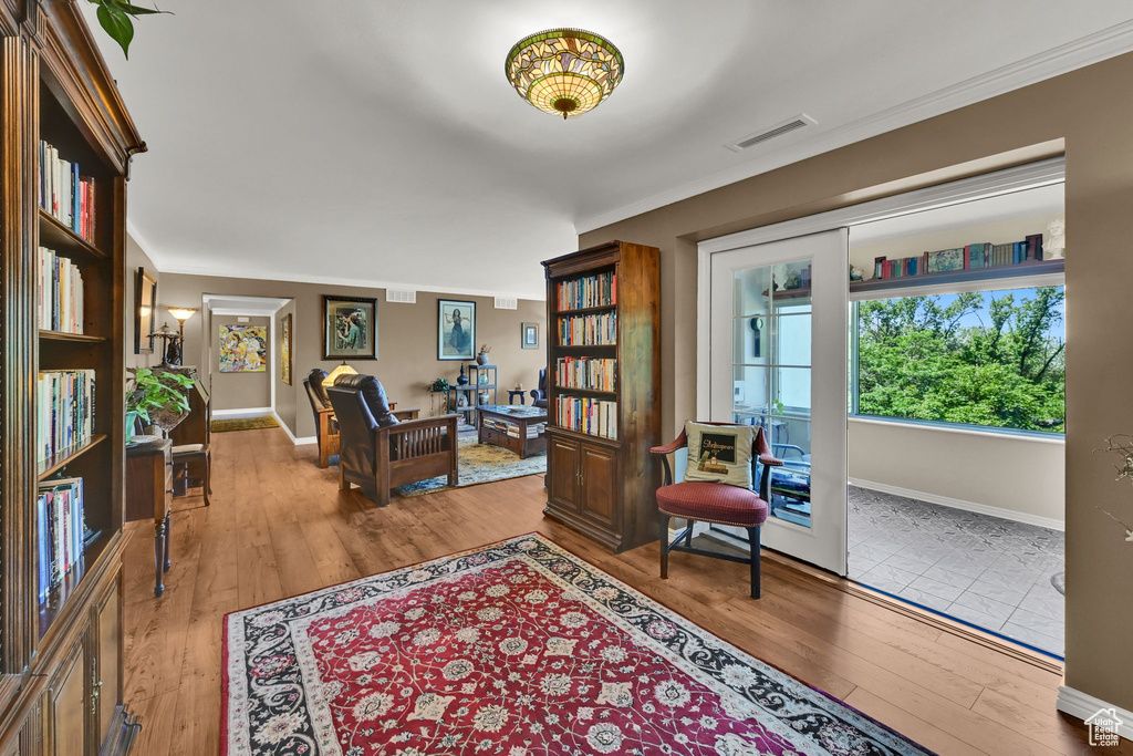 Sitting room featuring hardwood / wood-style floors and ornamental molding
