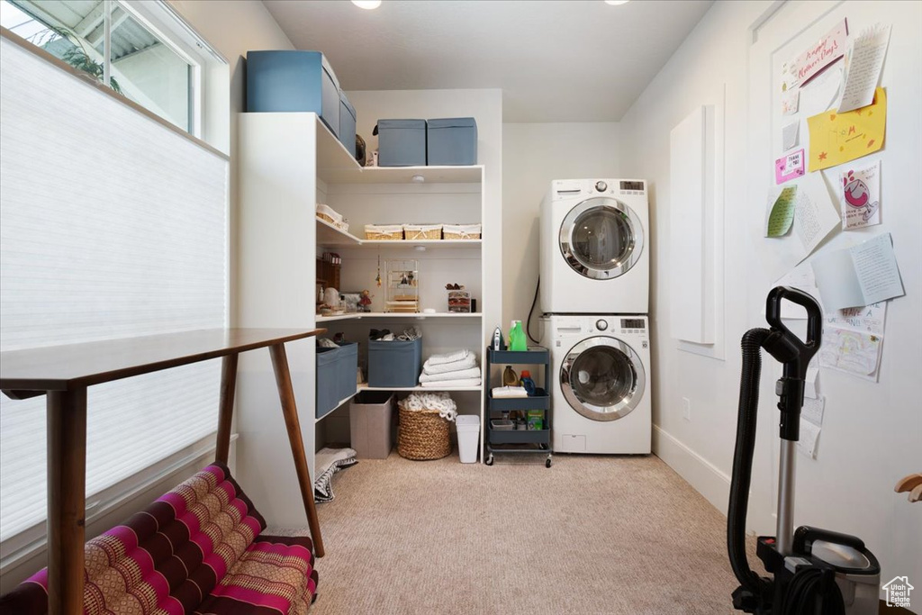 Washroom with stacked washer / drying machine and carpet