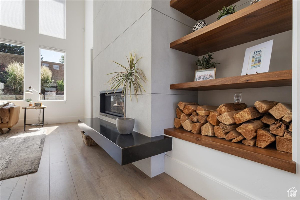 Detailed view of wood finished floors and a fireplace