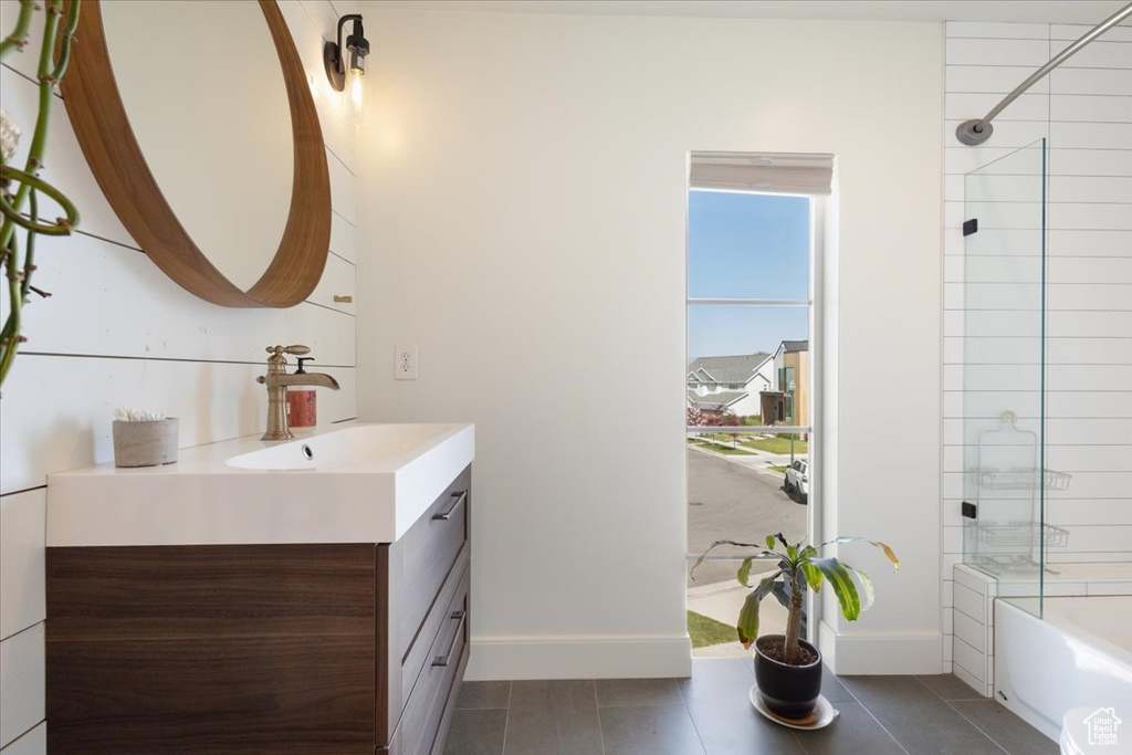 Bathroom with vanity, shower / bathtub combination, and tile patterned flooring