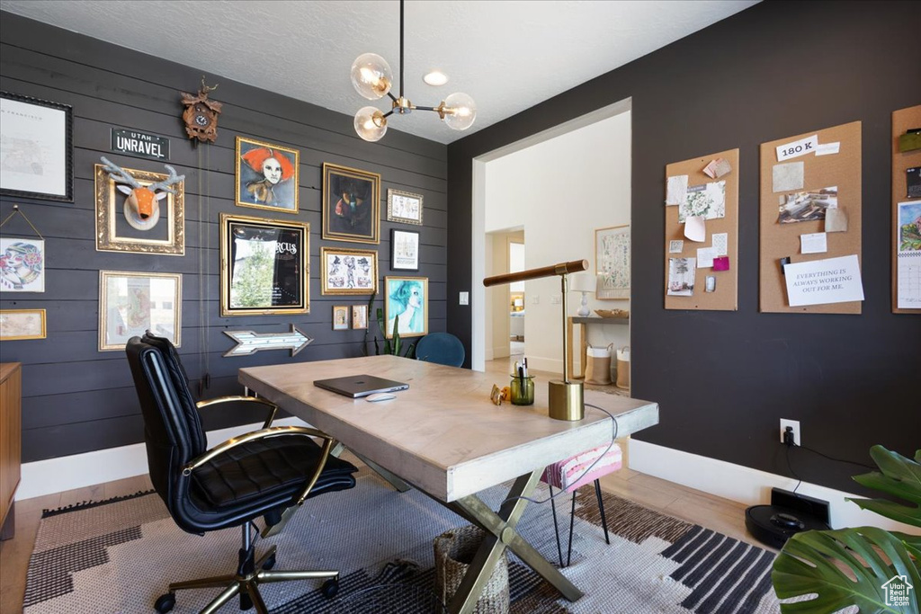 Office space with a chandelier and wood walls