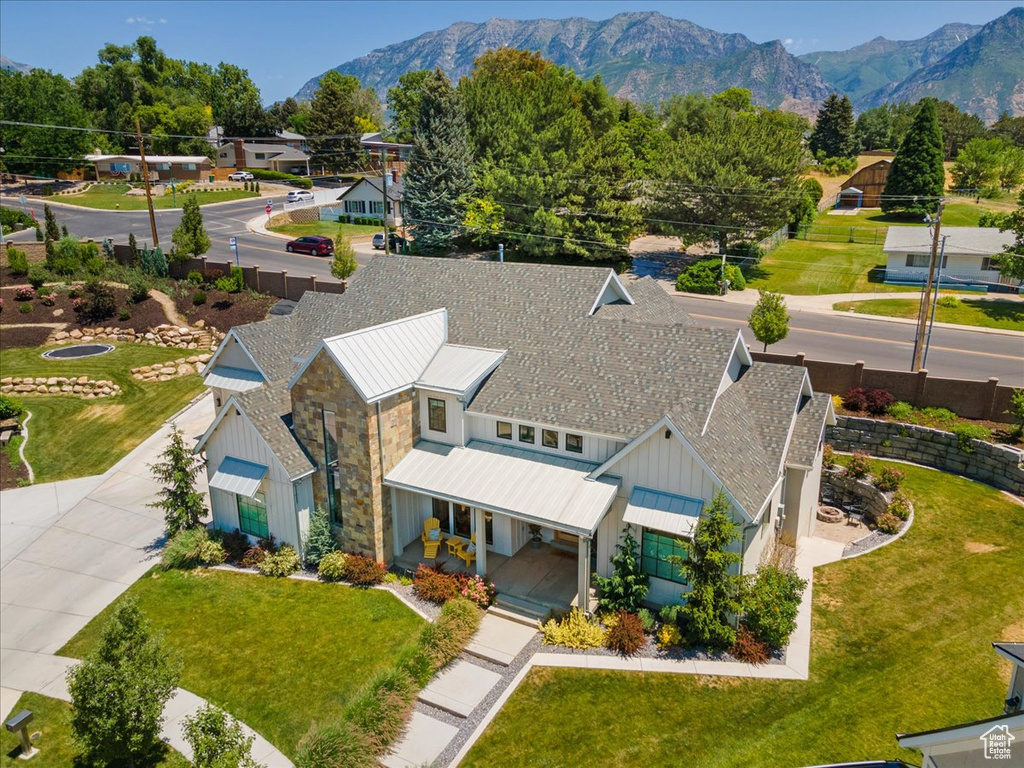 Aerial view of property and surrounding area featuring mountains