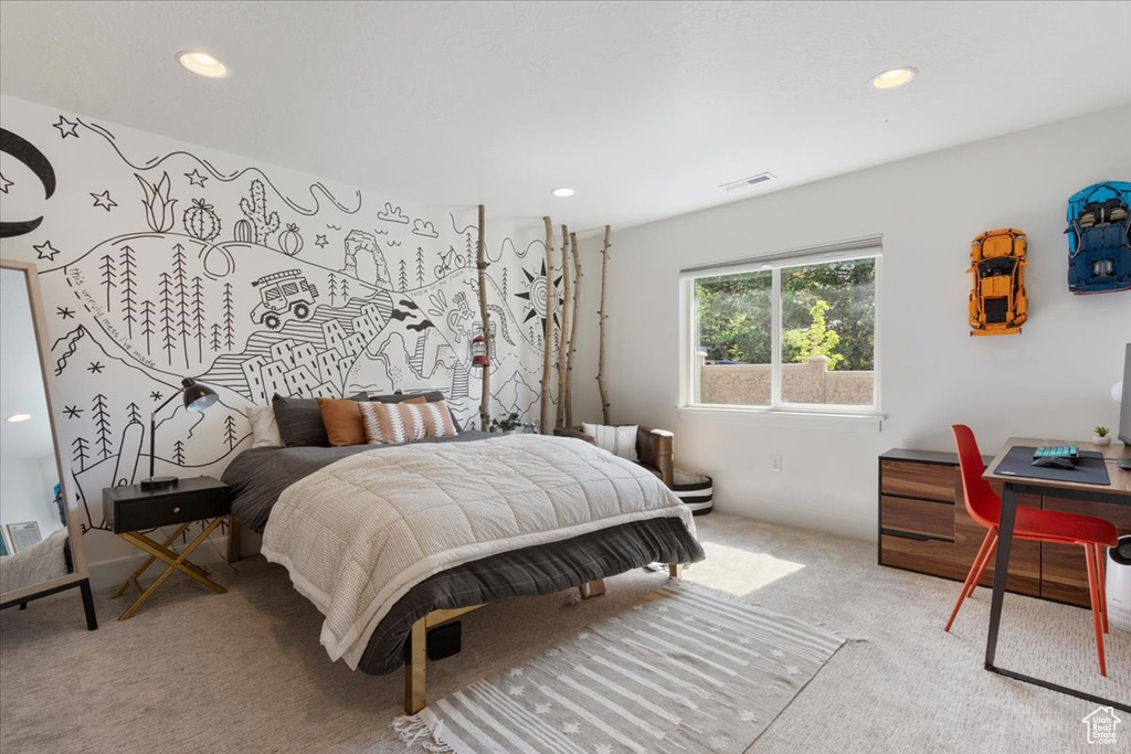 Carpeted bedroom with recessed lighting and an office area